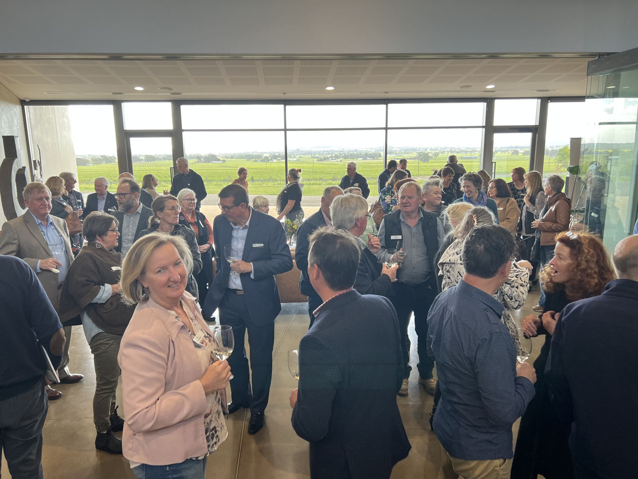 A group of people at the AGM enjoy the wine and view at Barossa Cellars