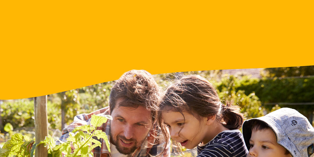 Thriving Regions Fund, an adult and two children in a garden tending to a plant.