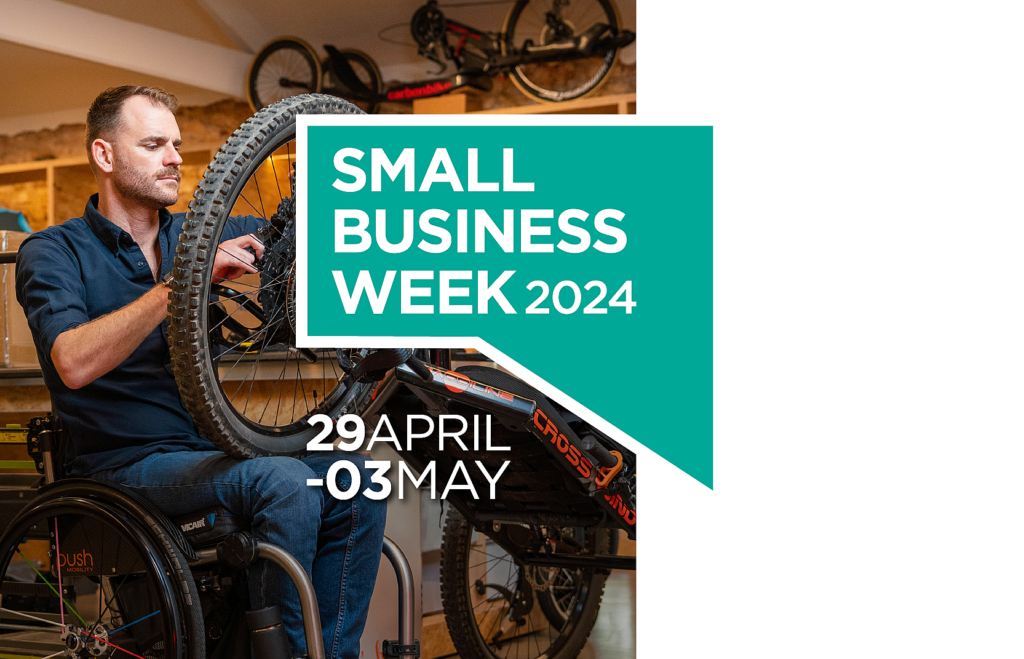 A man in a wheelchair fixing a wheel. Small Business Week 2024. 29 April - 03 May.
