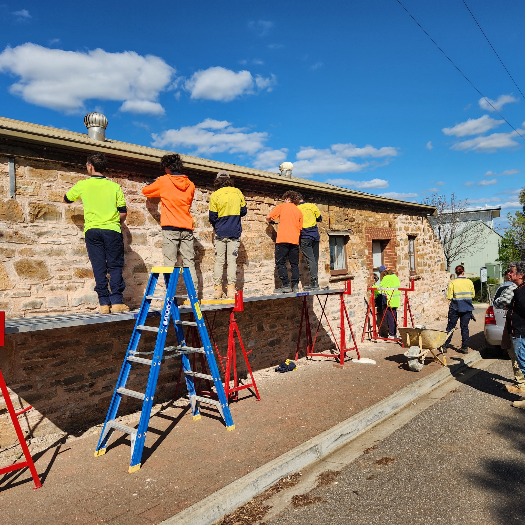 Kapunda High School students on ladders work on school renovations.