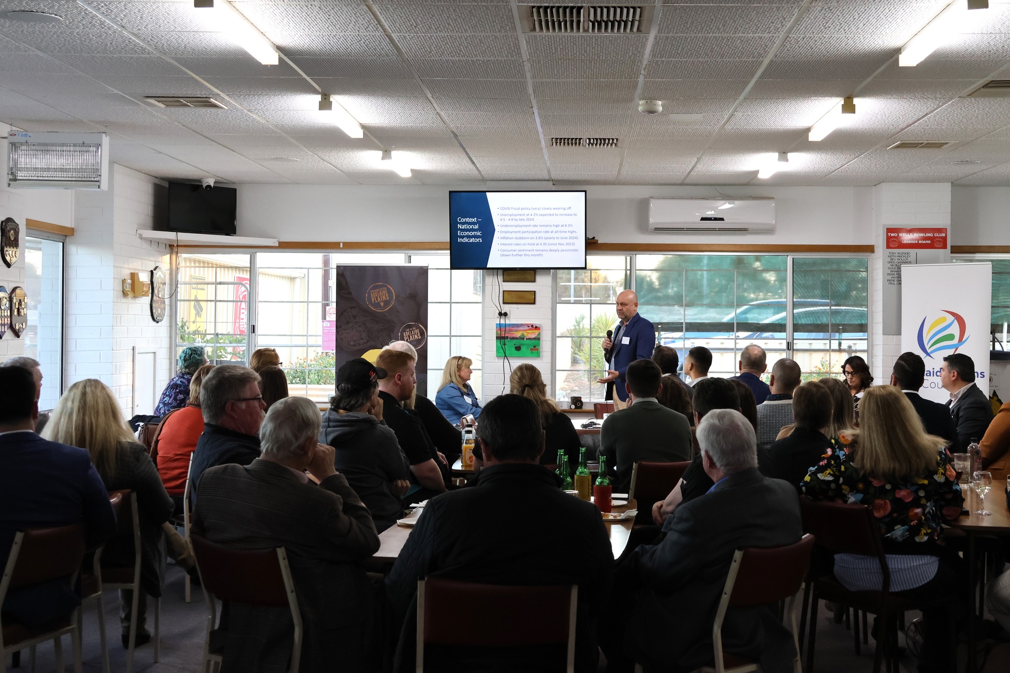 Overview of attendees networking during the event at Two Wells Bowling Club.