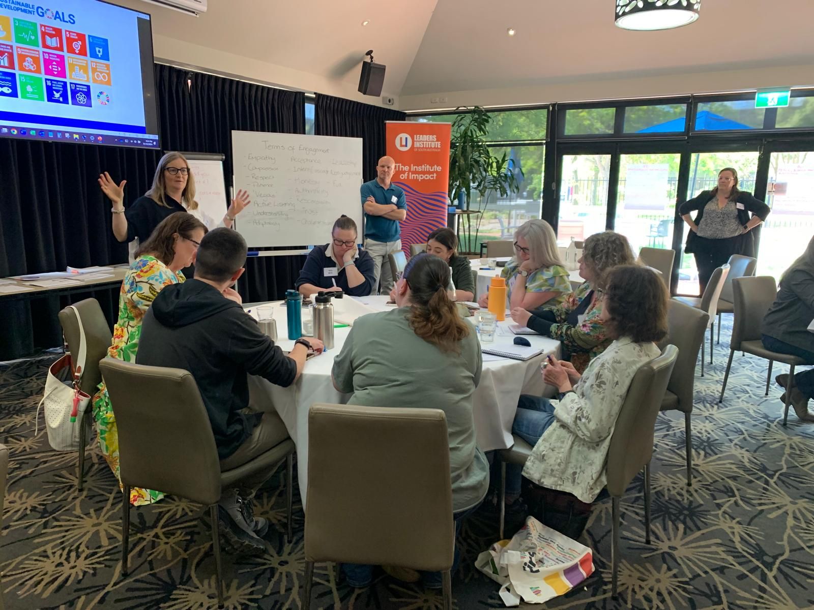 Facilitator leading a group discussion in a workshop setting.