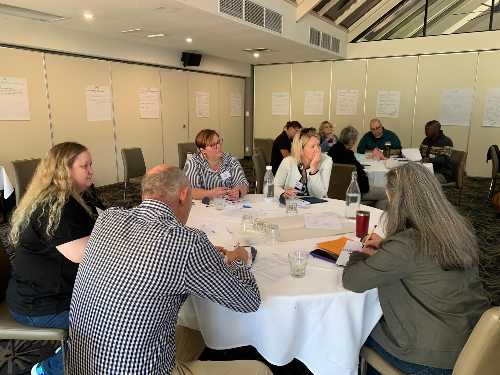 Group of community leaders in discussion during a workshop.