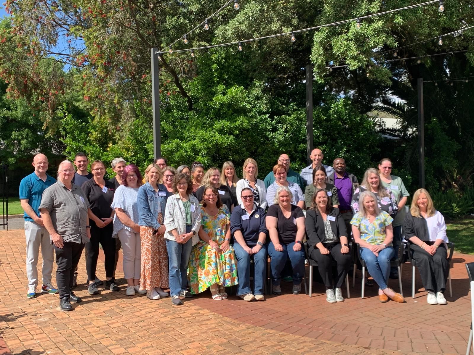 Group photo of Empowered Leaders program participants outdoors.